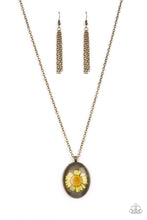 Load image into Gallery viewer, Featuring a rustic brass backdrop, a yellow daisy is encased inside a glassy brass frame at the bottom of an antiqued brass chain for a romantically rustic look. Features an adjustable clasp closure.
