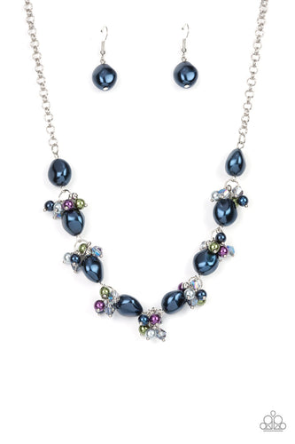 Imperfect blue pearls alternate with clusters of iridescent crystals and multicolored pearls below the collar, creating an effervescently elegant display. Features an adjustable clasp closure. 