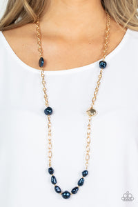 Infused with dainty gold beads, an elegant collection of imperfect blue pearls and gold beads asymmetrically adorn a substantial gold chain across the chest for an effortless elegance. Features an adjustable clasp closure. 