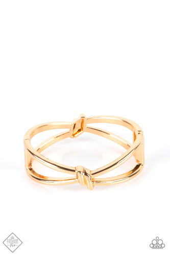 Striking gold bars delicately knot at the top and bottom of the wrist, resulting in a sultry bangle-like bracelet that's brushed in high-sheen shimmer. Features a hinged closure.  Sold as one individual bracelet.  New Kit Fashion Fix