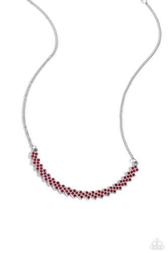 Dotted with fiery red rhinestones, dainty silver frames slant below the collar as they coalesce into a single curving centerpiece of dicey dazzle. Features an adjustable clasp closure.