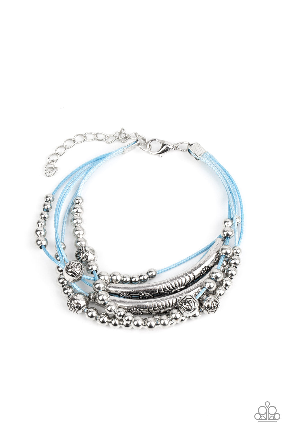 A whimsical collection of classic silver beads, floral stamped silver bars, and silver floral beads glide along layers of blue cording, creating noisemaking layers around the wrist. Features an adjustable clasp closure.