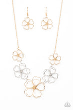 Load image into Gallery viewer, Glistening silver and gold wires delicately twist into oversized blossoms. Gradually increasing in size, the 3D frames elegantly pop beneath the collar. Features an adjustable clasp closure.
