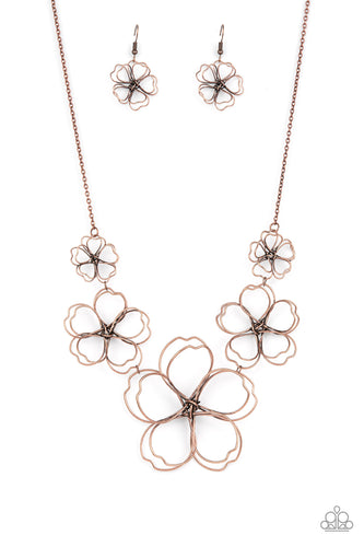 Rustic copper wire delicately twists into oversized blossoms. Gradually increasing in size, the 3D frames elegantly pop beneath the collar. Features an adjustable clasp closure. 