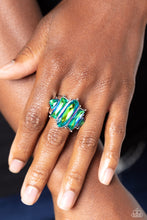 Load image into Gallery viewer, Featuring a stellar UV finish, an iridescent collection of triangular, emerald, and oval cut green rhinestones are encrusted across the center of a thick silver band for an out-of-this-world fashion. Features a stretchy band for a flexible fit.  Due to its prismatic palette, color may vary.
