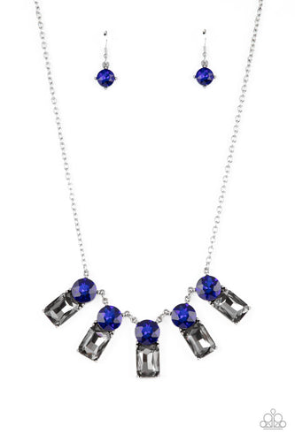 A sparkly row of oversized blue gems regally sit atop emerald cut smoky rhinestone bases as they delicately link along a dainty silver chain below the collar, resulting in a royal glamorous centerpiece. Features an adjustable clasp closure.