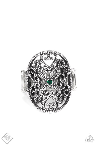 Whimsical heart-shaped studded filigree replays in a fanciful fashion inside a daintily studded antiqued silver frame. A single petite emerald green rhinestone rests in the center adding a splash of charismatic color atop the finger. Features a stretchy band for a flexible fit.  Sold as one individual ring.  Fashion Fix