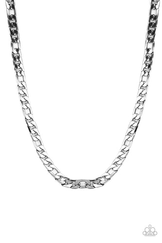 A faceted strand of oversized gunmetal curb chain drapes across the chest, resulting in an edgy centerpiece. Features an adjustable clasp closure. 