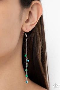 Featuring stellar iridescence, a dainty collection of glassy green rhinestones tumble down a lengthened silver chain for a twinkly tasseled look. Earring attaches to a standard fishhook fitting.