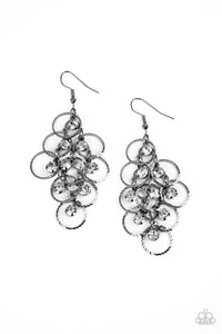 Shimmering rows of glassy white rhinestones and textured gunmetal hoops cascade from a netted metallic backdrop, interlocking into a dizzyingly dazzling lure. Earring attaches to a standard fishhook fitting.