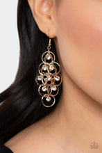 Load image into Gallery viewer, Shimmering rows of glassy white rhinestones and textured gold hoops cascade from a netted metallic backdrop, interlocking into a dizzyingly dazzling lure. Earring attaches to a standard fishhook fitting. 
