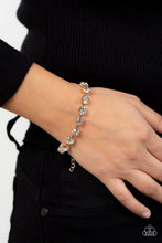 Load image into Gallery viewer, Featuring pronged gold fittings, an oversized row of glassy white rhinestones connect around the wrist for a glamorous pop of glitz. Features an adjustable clasp closure.
