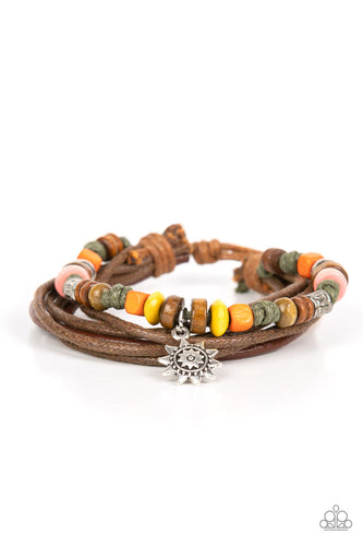 Featuring a silver sun charm, a strand of colorful wooden beads and shiny silver accents joins layers of leathery and shiny brown cording around the wrist for a colorfully urban look. Features an adjustable sliding knot closure.