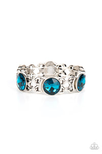 Featuring edgy chain-like fittings, a sparkly series of oversized blue rhinestones are threaded along stretchy bands around the wrist for a dramatic pop of glitz. 