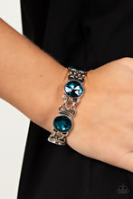 Load image into Gallery viewer, Featuring edgy chain-like fittings, a sparkly series of oversized blue rhinestones are threaded along stretchy bands around the wrist for a dramatic pop of glitz. 
