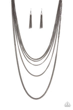 Load image into Gallery viewer, An intense display of mismatched gunmetal chains boldly layer across the chest, resulting in an edgy industrial vibe. Features an adjustable clasp closure. Sold as one individual necklace. Includes one pair of matching earrings.
