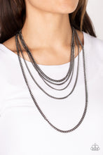 Load image into Gallery viewer, An intense display of mismatched gunmetal chains boldly layer across the chest, resulting in an edgy industrial vibe. Features an adjustable clasp closure. Sold as one individual necklace. Includes one pair of matching earrings.
