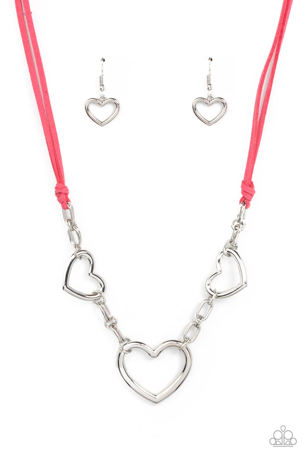 Strands of pink suede knot around sections of chunky silver chains that have been adorned in oversized silver heart frames, resulting in a flirtatious display below the collar. Features an adjustable clasp closure.