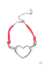 Load image into Gallery viewer, Strands of pink suede knot around sections of chunky silver chains that have been adorned in an oversized silver heart frame, resulting in a flirtatious display around the wrist. Features an adjustable clasp closure. 
