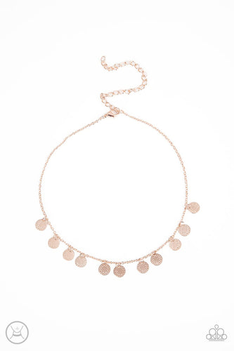 A dainty collection of mandala-like rose gold discs swings from a shiny rose gold chain, creating a shimmery radiance around the neck. Features an adjustable clasp closure.