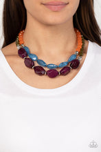Load image into Gallery viewer, Faceted strands of opaque orange and Olive Branch crystal-like beads give way to a colorful assortment of oversized blue and plum crystal-like accents. Shiny silver beads adorn the hearty layers, adding a dash of metallic glitz to the tropical inspired display. Features an adjustable clasp closure. 
