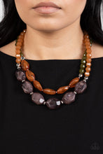 Load image into Gallery viewer, Faceted strands of cloudy brown and Olive Branch crystal-like beads give way to a colorful assortment of oversized brown and smoky black crystal-like accents. Shiny silver beads adorn the hearty layers, adding a dash of metallic glitz to the tropical inspired display. Features an adjustable clasp closure. 
