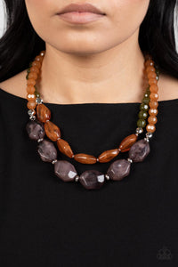 Faceted strands of cloudy brown and Olive Branch crystal-like beads give way to a colorful assortment of oversized brown and smoky black crystal-like accents. Shiny silver beads adorn the hearty layers, adding a dash of metallic glitz to the tropical inspired display. Features an adjustable clasp closure. 