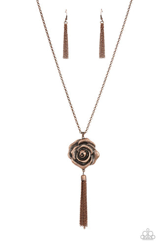 A rustic copper chain tassel dances from the bottom of an oversized copper rosebud frame, resulting in a vintage inspired pendant at the bottom of an extended copper chain. Features an adjustable clasp closure. 
