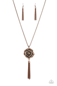 A rustic copper chain tassel dances from the bottom of an oversized copper rosebud frame, resulting in a vintage inspired pendant at the bottom of an extended copper chain. Features an adjustable clasp closure. 