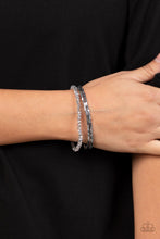 Load image into Gallery viewer, Two rows of dainty silver cube beads and one row of smoky crystal-like beads are threaded along stretchy bands around the wrist, creating stellar layers. 
