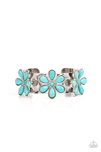 Dotted with turquoise stone centers, a trio of turquoise stone petaled flowers bloom atop a thick silver cuff for a whimsical pop of floral fashion. 