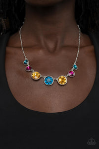 Encased in shiny silver frames, a glitzy collection of blue, yellow, and pink rhinestones gradually increase in size as they link below the collar for a flawless finish. Features an adjustable clasp closure.