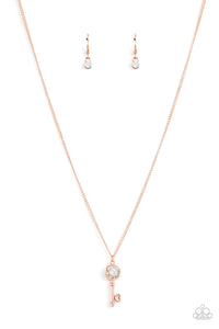Bordered in glassy white rhinestones, an opal white rhinestone adorns a shiny copper key pendant at the bottom of a dainty shiny copper chain for a whimsical fashion. Features an adjustable clasp closure.