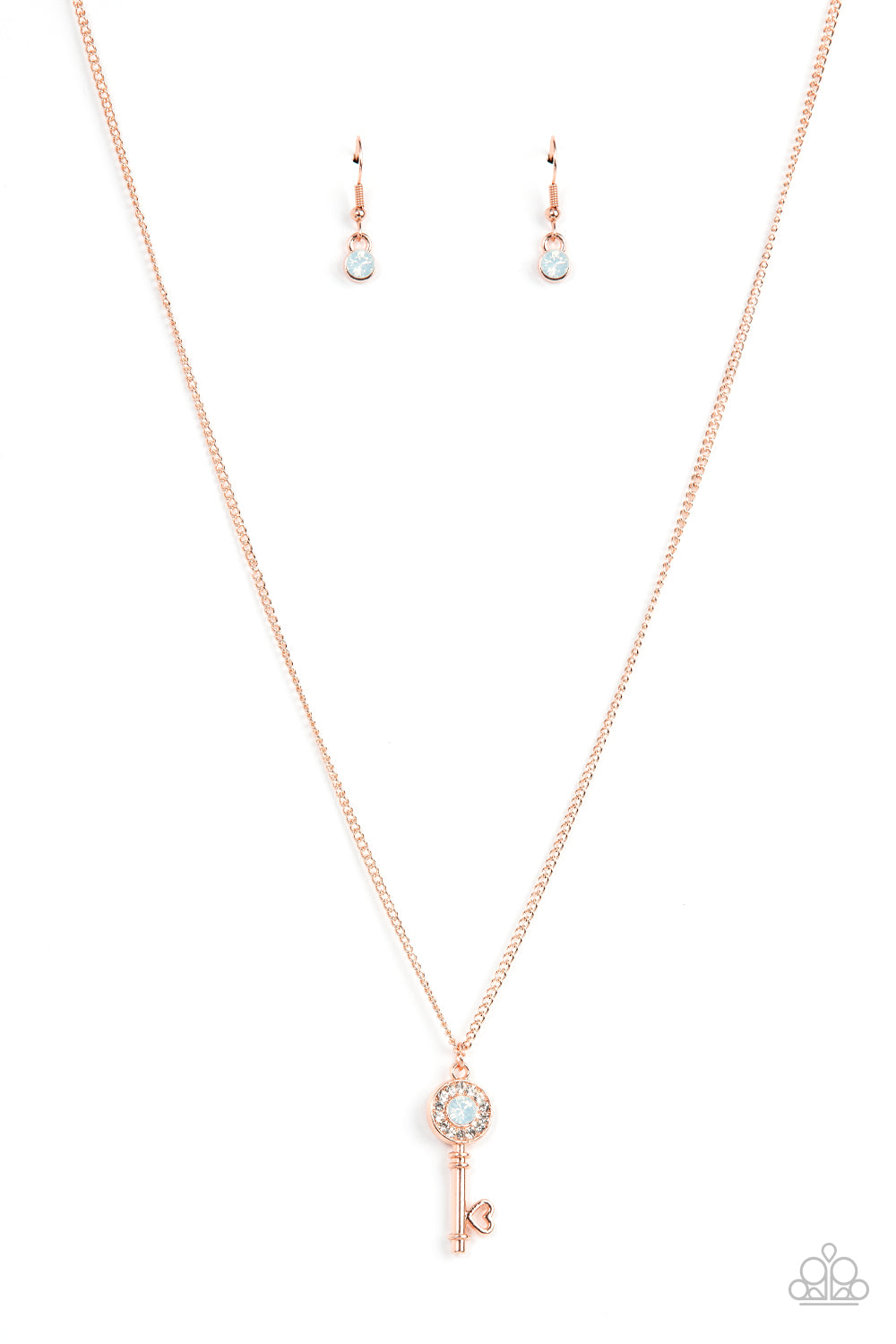 Bordered in glassy white rhinestones, an opal white rhinestone adorns a shiny copper key pendant at the bottom of a dainty shiny copper chain for a whimsical fashion. Features an adjustable clasp closure.