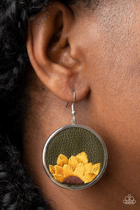 A golden yellow and brown threaded sunflower is stitched into the bottom of an Olive Branch leather frame that is encased in a sleek silver frame, resulting in a whimsical floral fashion. Earring attaches to a standard fishhook fitting.