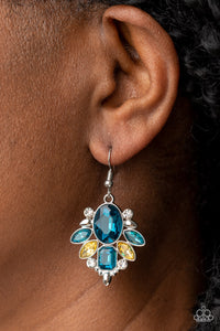 A brilliant blue gem makes a sparkling centerpiece amidst a glitzy fringe of marquise, round, and emerald cut blue, yellow, and white rhinestones resulting in a timeless lure. Earring attaches to a standard fishhook fitting. 