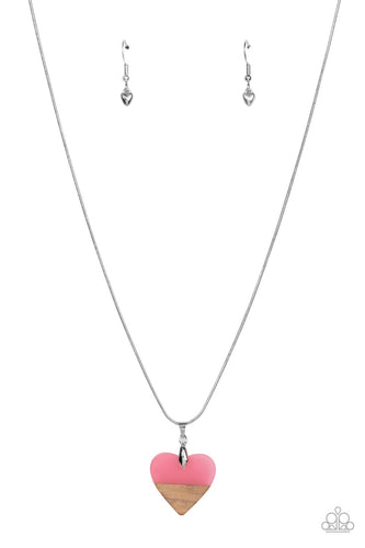 The tip of a pink acrylic heart attaches to a wooden accent, resulting in a colorfully free-spirited pendant below the collar. Features an adjustable clasp closure.