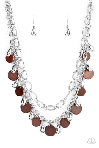  A pair of mismatched chunky silver chains layer below the collar. Shiny silver teardrop beads and brown shell-like discs dance from the bottom of the lowermost chain, creating a tropical inspired fringe. Features an adjustable clasp closure.