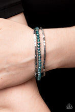 Load image into Gallery viewer, Two rows of dainty silver cube beads and one row of iridescent blue crystal-like beads are threaded along stretchy bands around the wrist, creating stellar layers. 
