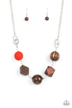 Load image into Gallery viewer, Infused with a solitaire red wooden bead, a mismatched assortment of studded silver hoops, textured silver rings, and oversized brown wooden beads delicately connect across the chest for a stylishly handcrafted fashion. Features an adjustable clasp closure.
