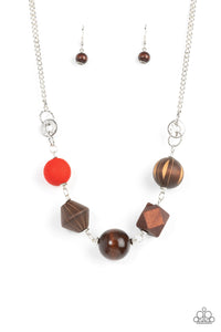 Infused with a solitaire red wooden bead, a mismatched assortment of studded silver hoops, textured silver rings, and oversized brown wooden beads delicately connect across the chest for a stylishly handcrafted fashion. Features an adjustable clasp closure.