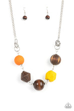 Load image into Gallery viewer, Infused with yellow and orange wooden beads, a mismatched assortment of studded silver hoops, textured silver rings, and oversized brown wooden beads delicately connect across the chest for a stylishly handcrafted fashion. Features an adjustable clasp closure.
