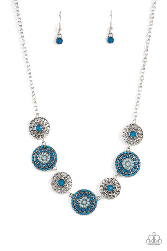 Bursts of faceted Mykonos Blue beads and sparkling opal blue rhinestones radiate from the centers of antiqued silver frames, while smaller airy frames are dotted with Mykonos Blue centers. The whimsical designs alternate around the collar making a dazzling display. Features an adjustable clasp closure.