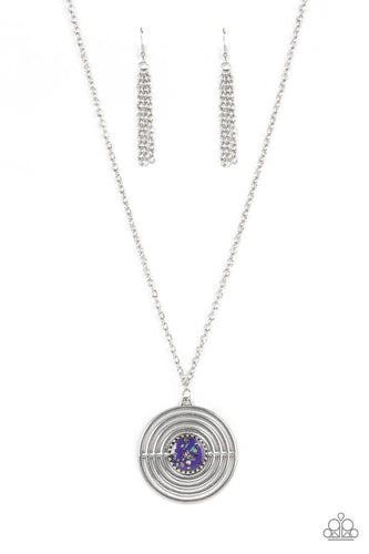 Flecked in iridescent shell-like accents, a studded purple frame adorns the center of an oversized silver pendant rippling with concentric circles at the bottom of an extended silver chain for a dizzying pop of color. Features an adjustable clasp closure.