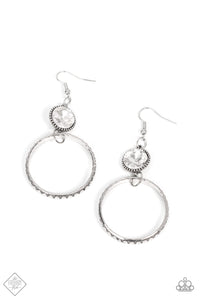 The outer edge of a silver ring is stamped with a flattened dot motif as it swings below a dramatic white rhinestone that sparkles inside a daintily dotted antiqued silver frame, creating an upscale, edgy modern lure. Earring attaches to a standard fishhook fitting.  Sold as one pair of earrings.  Fashion Fix