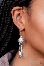 Load image into Gallery viewer, The outer edge of a silver ring is stamped with a flattened dot motif as it swings below a dramatic white rhinestone that sparkles inside a daintily dotted antiqued silver frame, creating an upscale, edgy modern lure. Earring attaches to a standard fishhook fitting.  Sold as one pair of earrings.  Fashion Fix
