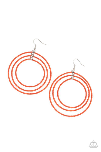 Three oversized rings of dainty orange seed beads ripple into colorfully layered hoops, resulting in a dizzying display. Earring attaches to a standard fishhook fitting.