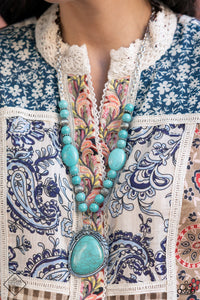 A lengthened silver chain flows into a succession of polished turquoise beads and silver accents. The flowy display gives way to an opulent turquoise stone that is pressed into an ornate silver frame. Adorned with fanciful antiqued silver flower, vine, and feather-like motifs, the elegantly rustic pendant makes a striking impact. Features an adjustable clasp closure.  Sold as one individual necklace. Includes one pair of matching earrings.  New Kit Fashion Fix