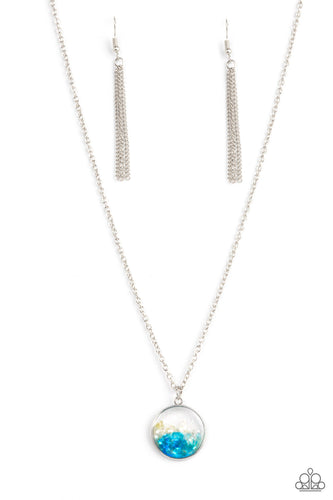 Crushed pieces of iridescent white and blue shell-like accents are encased in a glassy silver fitting at the bottom of a silver chain, resulting in a colorful pop of shimmer below the collar. Features an adjustable clasp closure. 