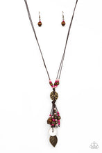 Load image into Gallery viewer, An earthy assortment of Pale Rosette and Fuchsia Fedora seed beads, rustic brass discs, and wooden accents glide along lengthy strands of brown cording that knot around a hammered brass disc. Tassels of matching beads, a white shell-like accent, floral silver bead, and brass leaf charm dance from the bottom, adding playful movement to the free-spirited display. Features an adjustable clasp closure.
